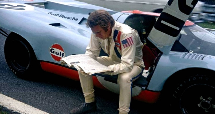 Porsche 917 Le Mans driver reading newspaper